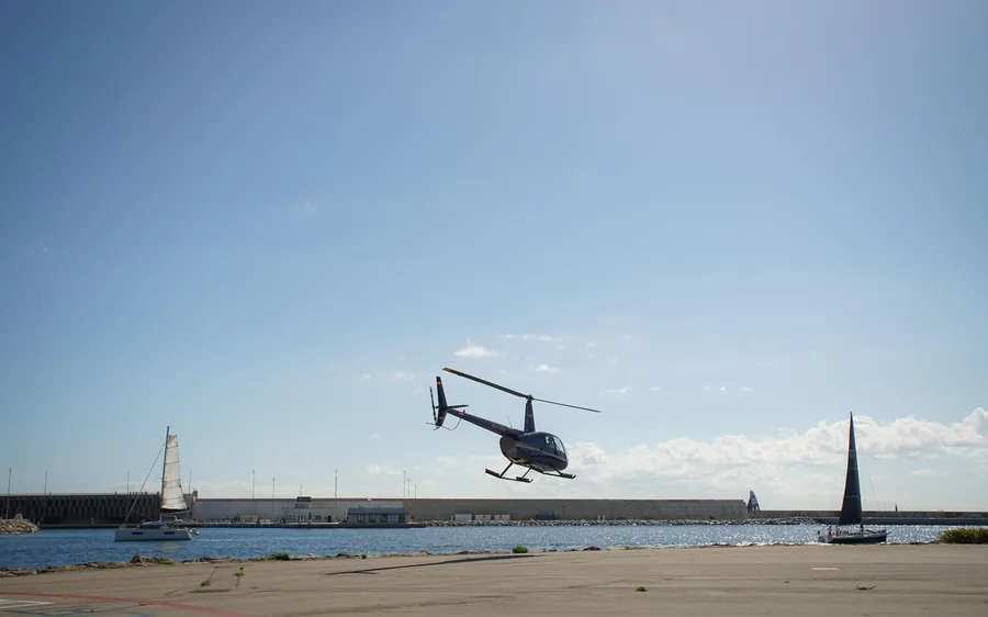 A helicopter over the breakwater at the Port of Barcelona