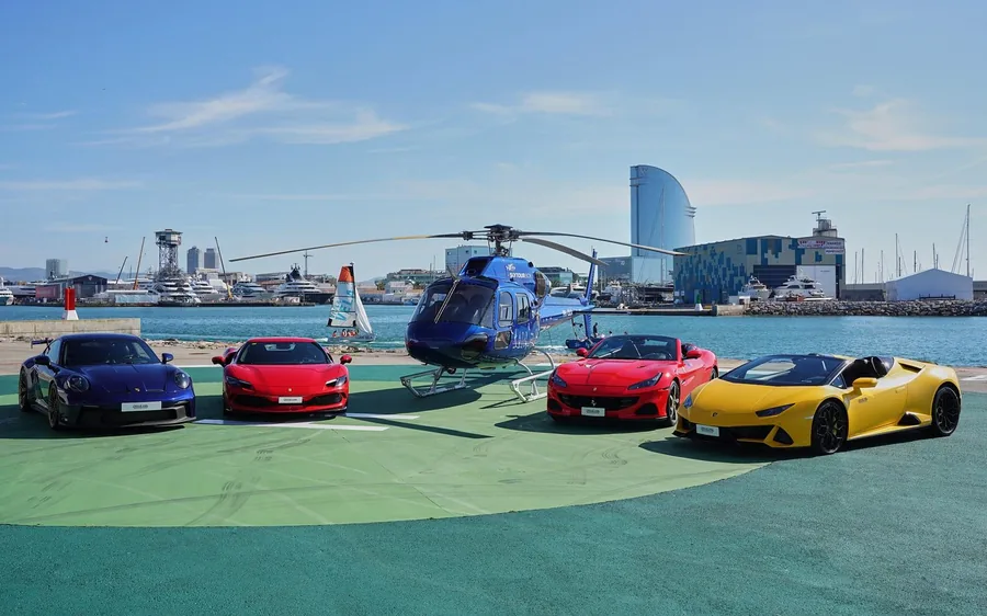Supercars and a helicopter on the apron at Barcelona Heliport